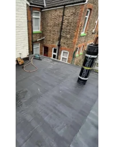 Flat roof with construction materials and tools.