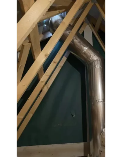 Attic with metal ductwork and wooden beams