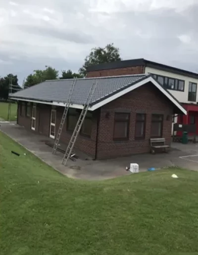 Brick building with ladders and cloudy sky