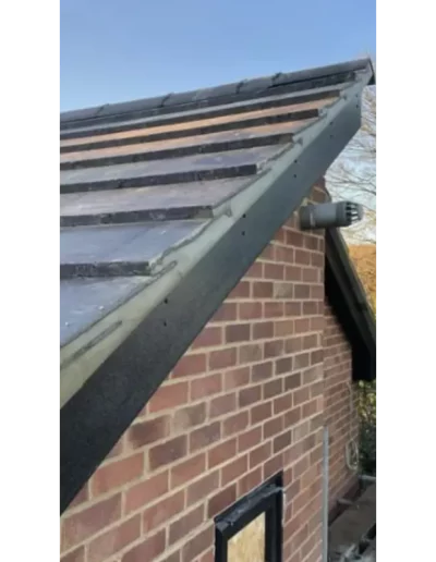 Brick house with new slate roof tiles.