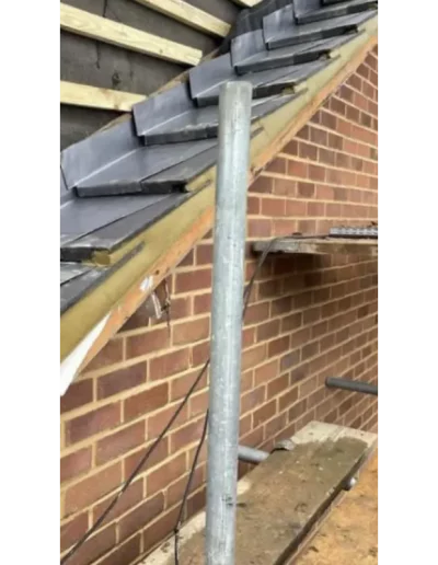 Brick wall under construction with roof support beam