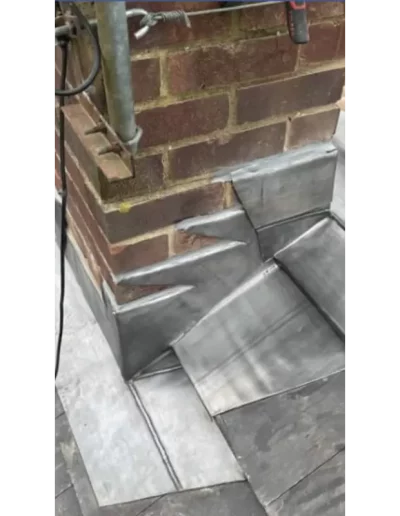 Brick chimney with metal roof flashing