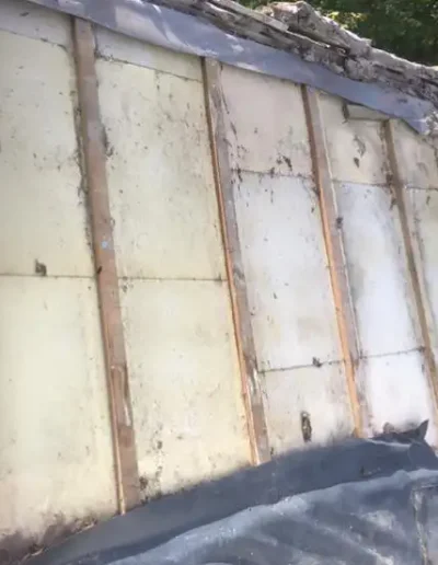 Old damaged rooftop with wooden supports.