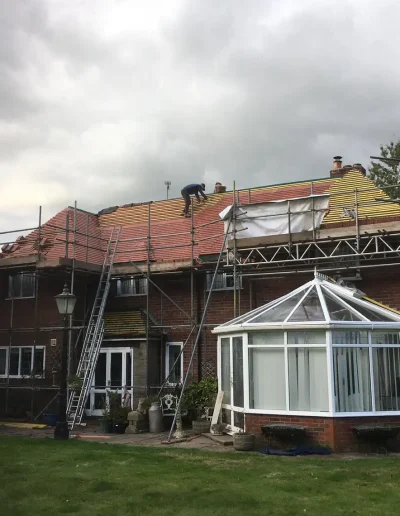 House under roof renovation with scaffolding